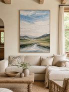 Modern textured mountain landscape painting by Evelyn Li displayed above a neutral sofa in a contemporary living room