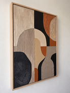 Side angle view of geometric abstract textured art, showing the 3D relief and natural wood frame thickness.