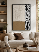 Neutral textured abstract painting displayed above a beige sofa in a contemporary organic modern living room