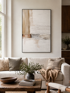 Neutral textured abstract painting displayed above a beige sofa in an organic modern living room