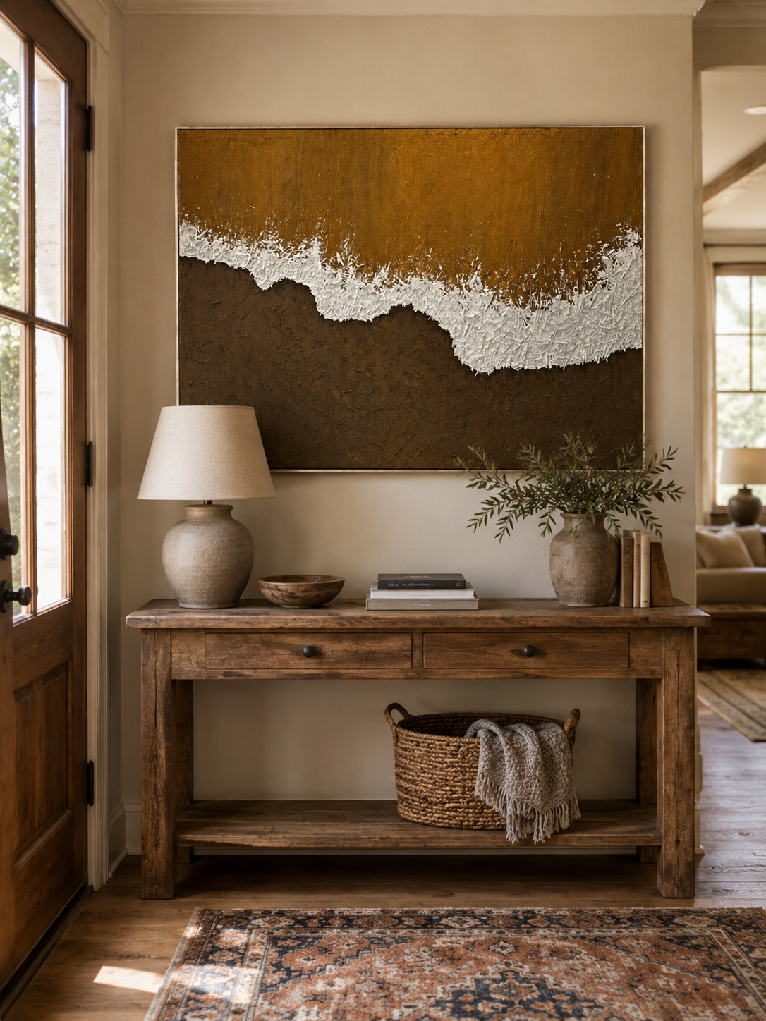 Wabi-Sabi brown coastal painting displayed above a wood console in an organic modern entryway