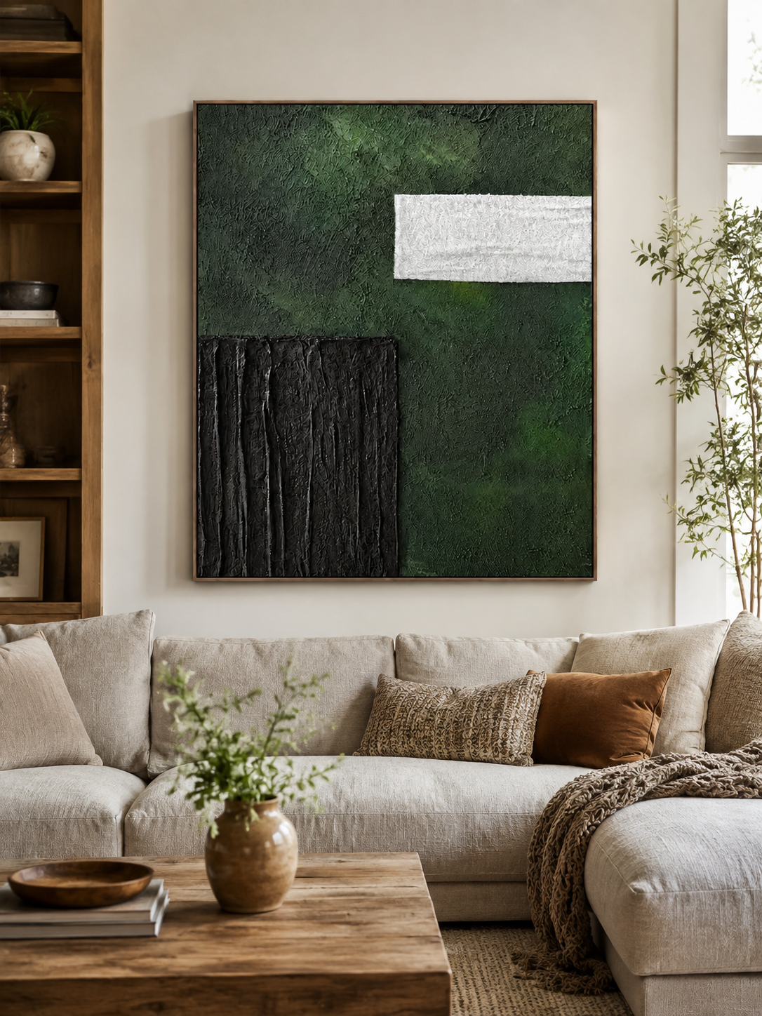 Green and black textured abstract painting displayed above neutral furniture in a modern living room