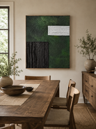 Hand-painted green textured wall art displayed in a modern dining room with walnut furniture