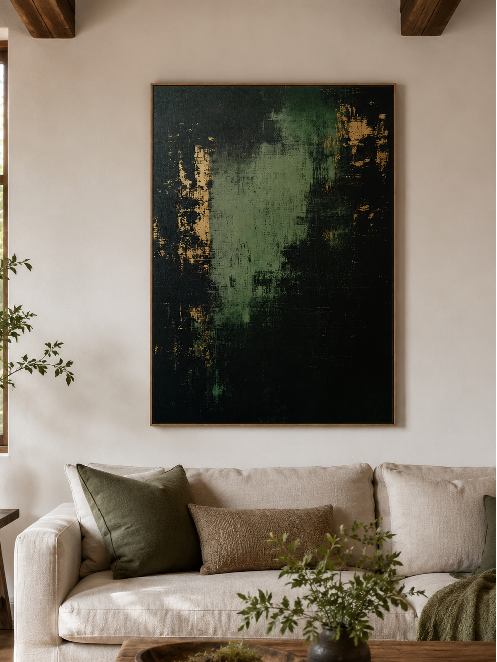 Dark green abstract painting displayed above neutral furniture in an organic modern living room