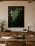 Hand-painted green and black abstract wall art displayed in a dining room with walnut furniture
