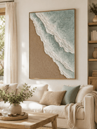 Sage green and beige ocean wave painting displayed above a neutral sofa in an organic modern living room