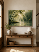 Horizontal sunlit forest painting displayed above a long wood console in a warm modern entryway