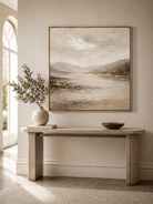 Modern textured neutral landscape wall art displayed above an entryway console in a contemporary home