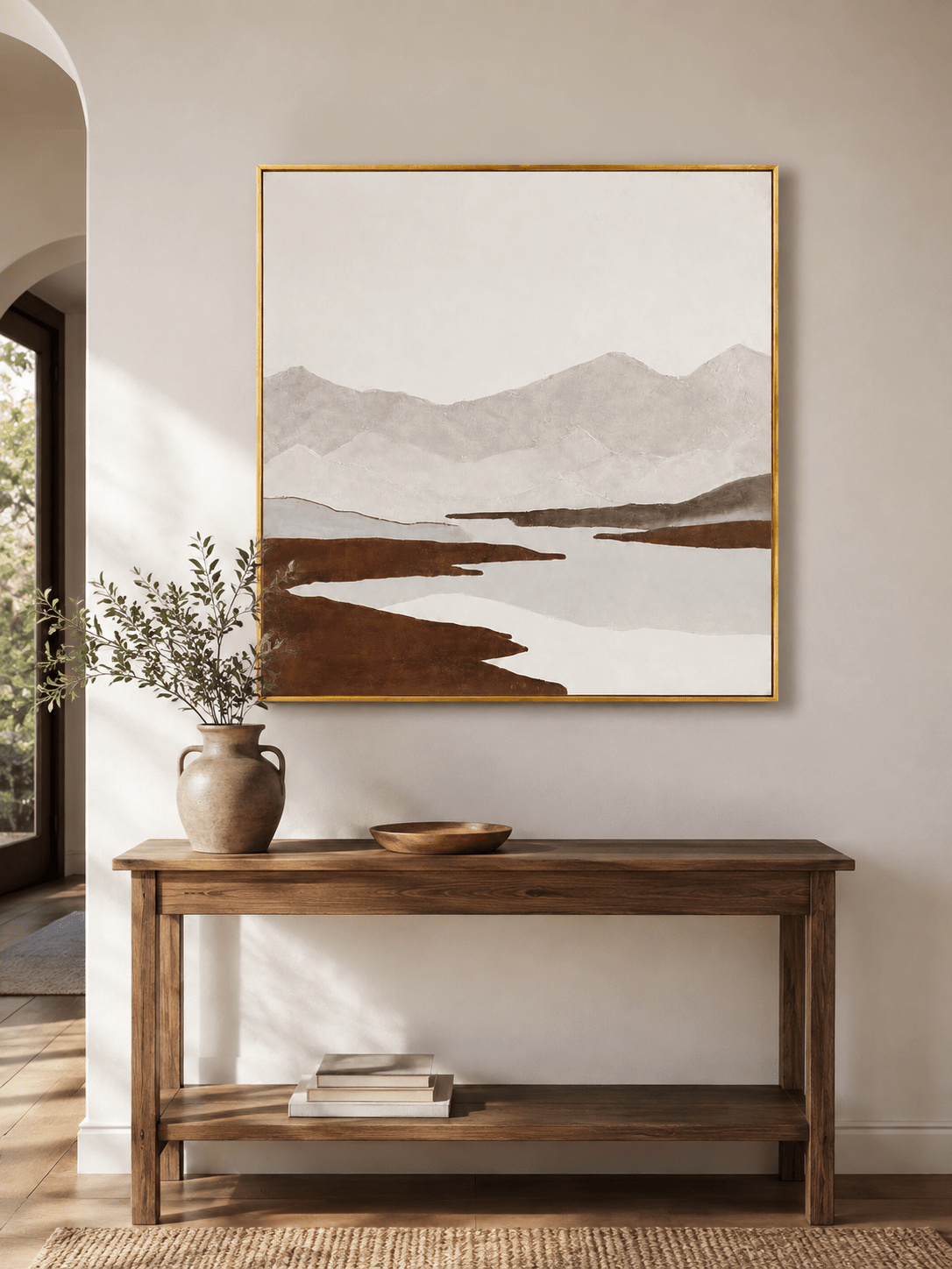 Neutral textured mountain river wall art displayed above an entryway console in a contemporary home