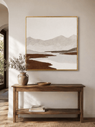Neutral textured mountain river wall art displayed above an entryway console in a contemporary home