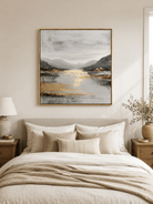 Neutral textured mountain lake painting displayed above the bed in a warm contemporary bedroom