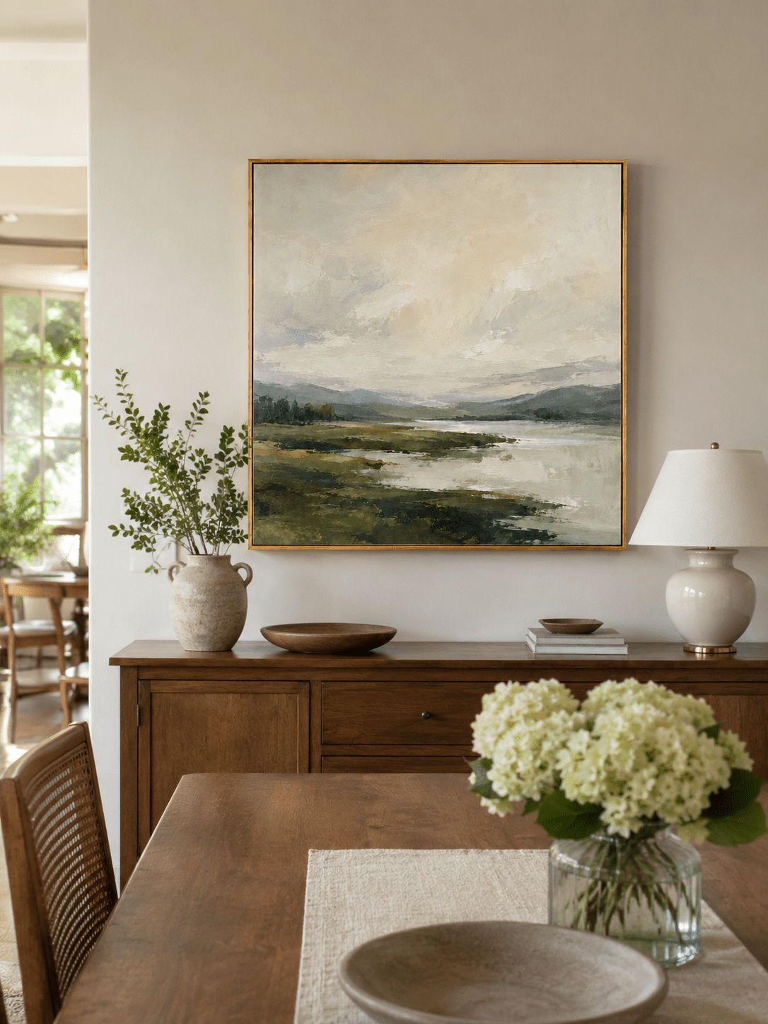 Large green and beige landscape wall art displayed in an organic modern open dining room