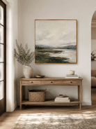Neutral green textured landscape wall art displayed above an entryway console in a contemporary home