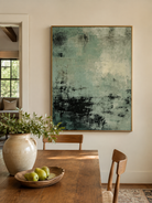 Textured sage green abstract wall art displayed in an open-plan dining room