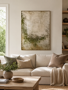 Moss green abstract wall art displayed above a neutral sofa in an organic modern living room