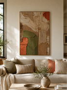 Wabi-sabi textured geometric wall art displayed above a neutral sofa in an organic modern living room