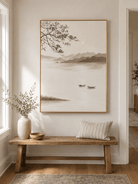 Minimalist lake landscape wall art above an entryway console in a neutral Japandi foyer