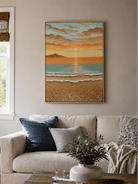 Textured coastal sunrise wall art above a neutral sofa in a modern coastal living room