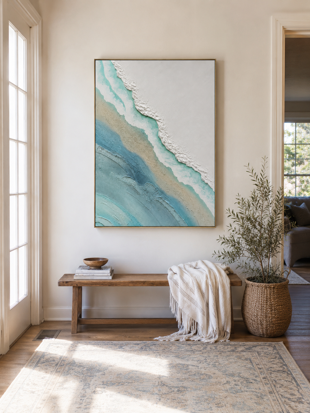 Minimalist coastal wall art above an entryway console in an airy organic modern foyer