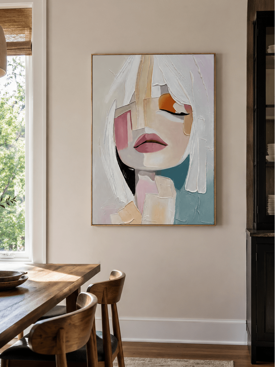 Modern abstract female portrait painting displayed in a neutral open-plan dining room