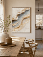 Neutral ocean wall art above an entryway console in an organic modern foyer