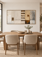 Large architectural textured wall art displayed in an open dining room with walnut and stone furniture