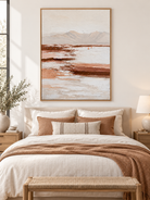 Textured blush beige and terracotta landscape painting displayed above a dresser in a neutral bedroom