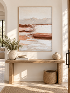 Large vertical earth tone landscape wall art displayed above an entryway console in a wabi-sabi interior