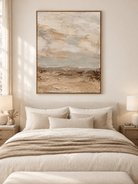 Beige and greige textured abstract landscape painting displayed in a warm neutral bedroom
