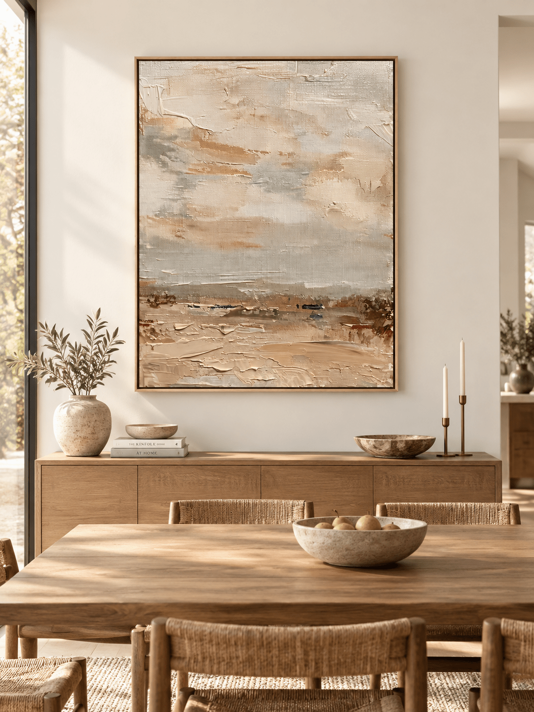 Vertical neutral textured wall art displayed in an open dining room with natural wood and stone furniture