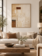 Large neutral textured geometric abstract wall art displayed above a sofa in a modern organic living room