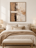 Beige and brown textured abstract painting displayed above a bed in a warm minimalist bedroom