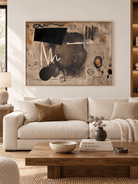 Large horizontal neutral abstract wall art displayed above a sofa in a contemporary living room
