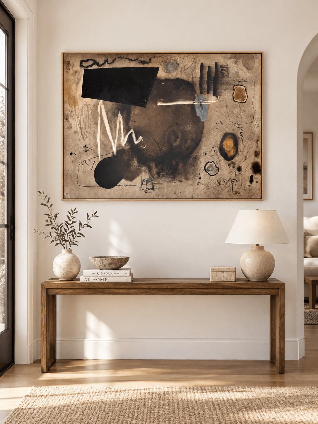 Large horizontal contemporary abstract painting displayed above a console in a modern entryway