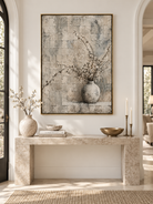 Vertical neutral floral vase wall art displayed above a console in a Wabi Sabi inspired entryway