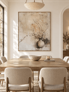 Hand-painted neutral botanical wall art displayed in a modern organic open-plan dining room