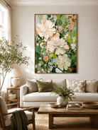 Large textured ivory floral wall art displayed in a modern living room with beige and neutral furniture