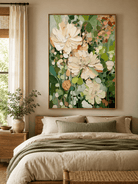 Cream and sage green textured flower painting displayed in a warm neutral modern bedroom