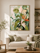Large pink and green botanical wall art displayed in a modern living room with beige neutral furniture