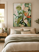 Textured blush pink and sage green floral painting displayed in a warm neutral contemporary bedroom