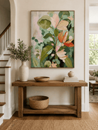 Vertical abstract floral wall art displayed above an entryway console in an organic modern interior