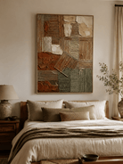 Earth tone wabi-sabi geometric painting displayed in a minimalist bedroom with cream and natural wood decor