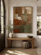 Vertical textured geometric wall art displayed above an entryway console in a wabi-sabi modern interior