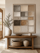 Vertical neutral textured wall art displayed above an entryway console in a Japandi-inspired interior