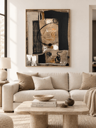 Large black and beige abstract wall art displayed above a sofa in a contemporary living room