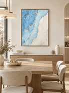 Hand-painted abstract coastline wall art displayed in a contemporary open-plan dining room