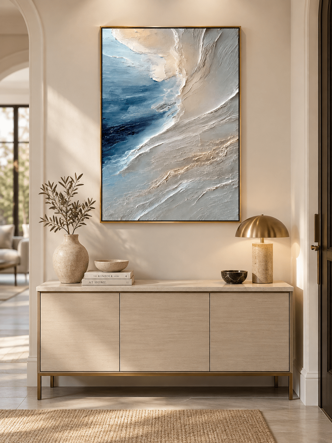 Vertical blue and gray textured coastal painting displayed above a console in a contemporary entryway