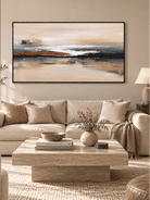 Large rust orange and charcoal abstract landscape painting displayed above a sofa in a contemporary living room
