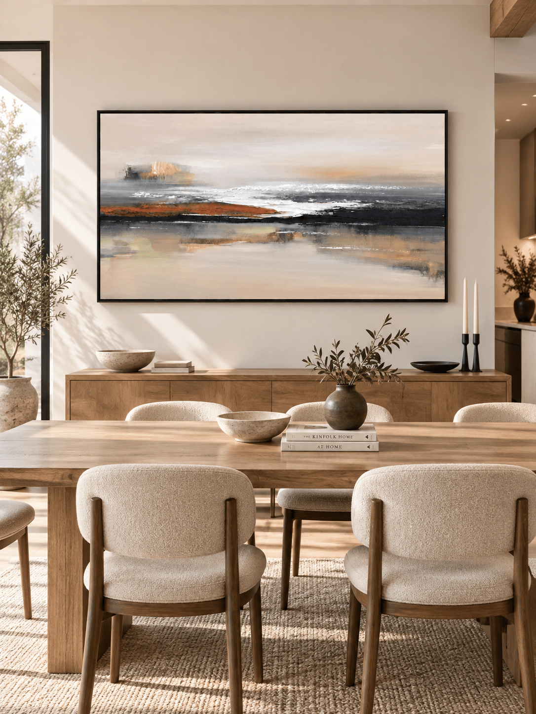 Hand-painted black and burnt orange abstract landscape displayed in a modern open-plan dining room