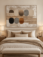 Neutral textured oval abstract painting displayed above a bed in a contemporary minimalist bedroom